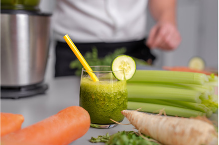 Green smoothie in glass with straw, a Food & Drink Photo by HalfPoint