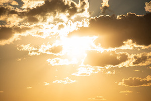 Sunset sky with clouds and sun