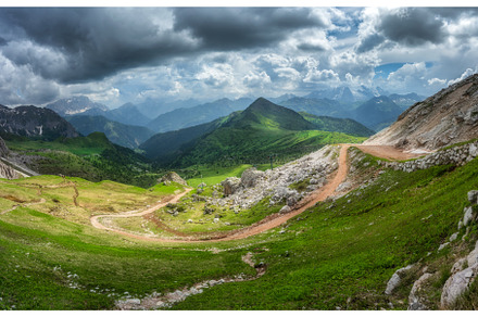 Winding mountain road in a vibrant, a Nature Photo by den-belitsky