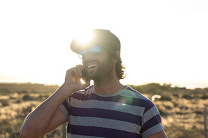 Handsome guy outdoor using phone containing adult, beard, and boy