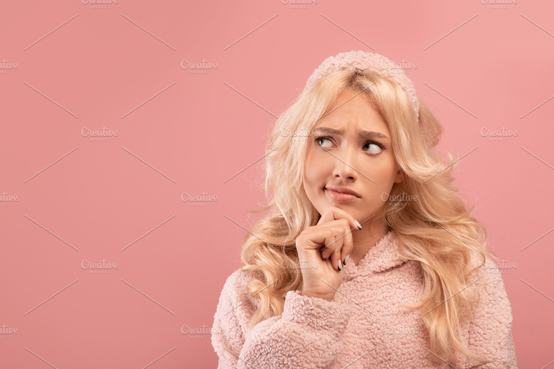 Making choice. Pensive young lady touching chin and looking aside at free space, a Photo by Prostock-Studio