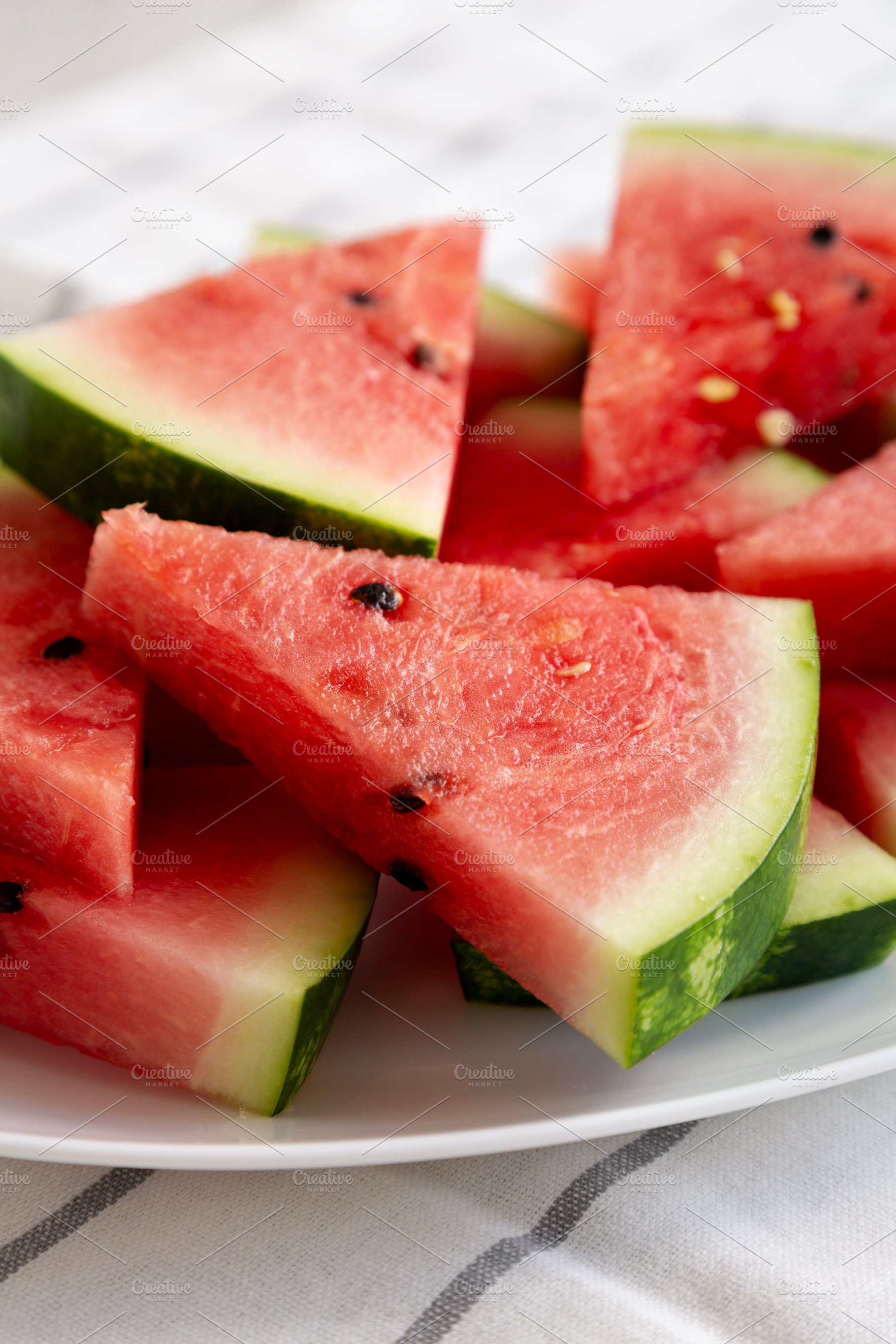 Raw Organic Watermelon Slices on a Plate, side view. Close-up., a Food & Drink Photo by LiudmylaChuhunova