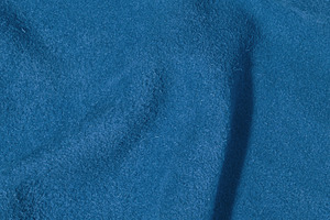Blue suede texture with creases, fabric for bags and shoes, a Background Photo by ndanko
