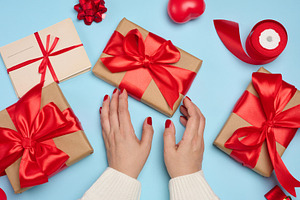 Preparing gifts for the holiday, gift boxes wrapped in red ribbo, a Holiday Photo by ndanko