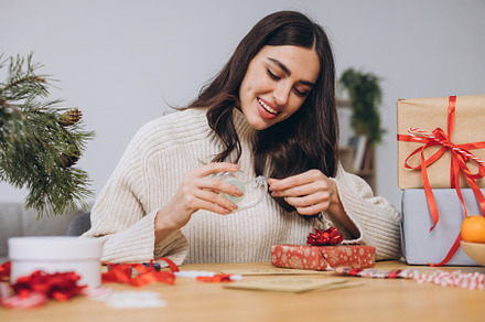 Woman wrapping Christmas Presents Gifts