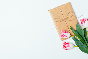 Flat lay composition of bouquet of tulips and gift box