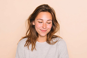 Smiling young woman in cozy gray sweater, a Person Photo by AlyaAnd