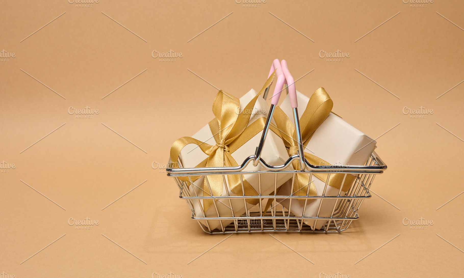 A stack of boxes tied with a golden ribbon on a beige background, a Holiday Photo by ndanko
