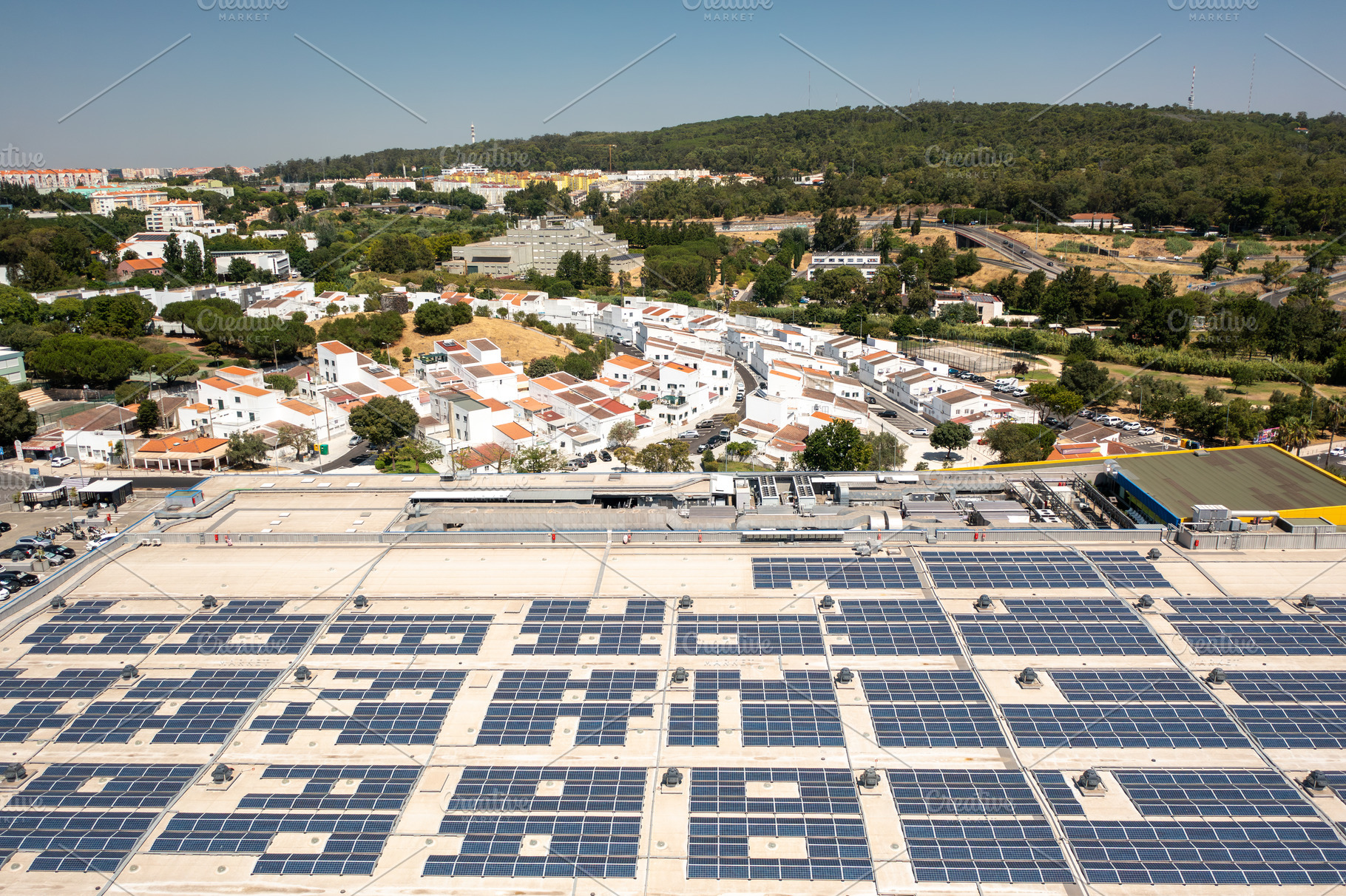 Solar panels on rooftop of shopping mall generating renewable energy, a Photo by andreonegin market