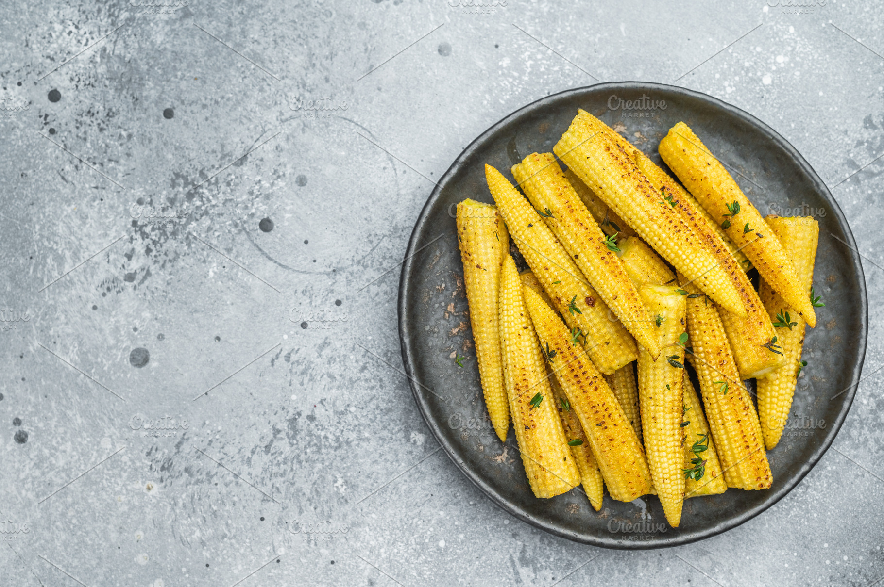 Golden roasted baby corn seasoned with thyme served on ceramic p, a Food & Drink Photo by composter-box@mail.ru