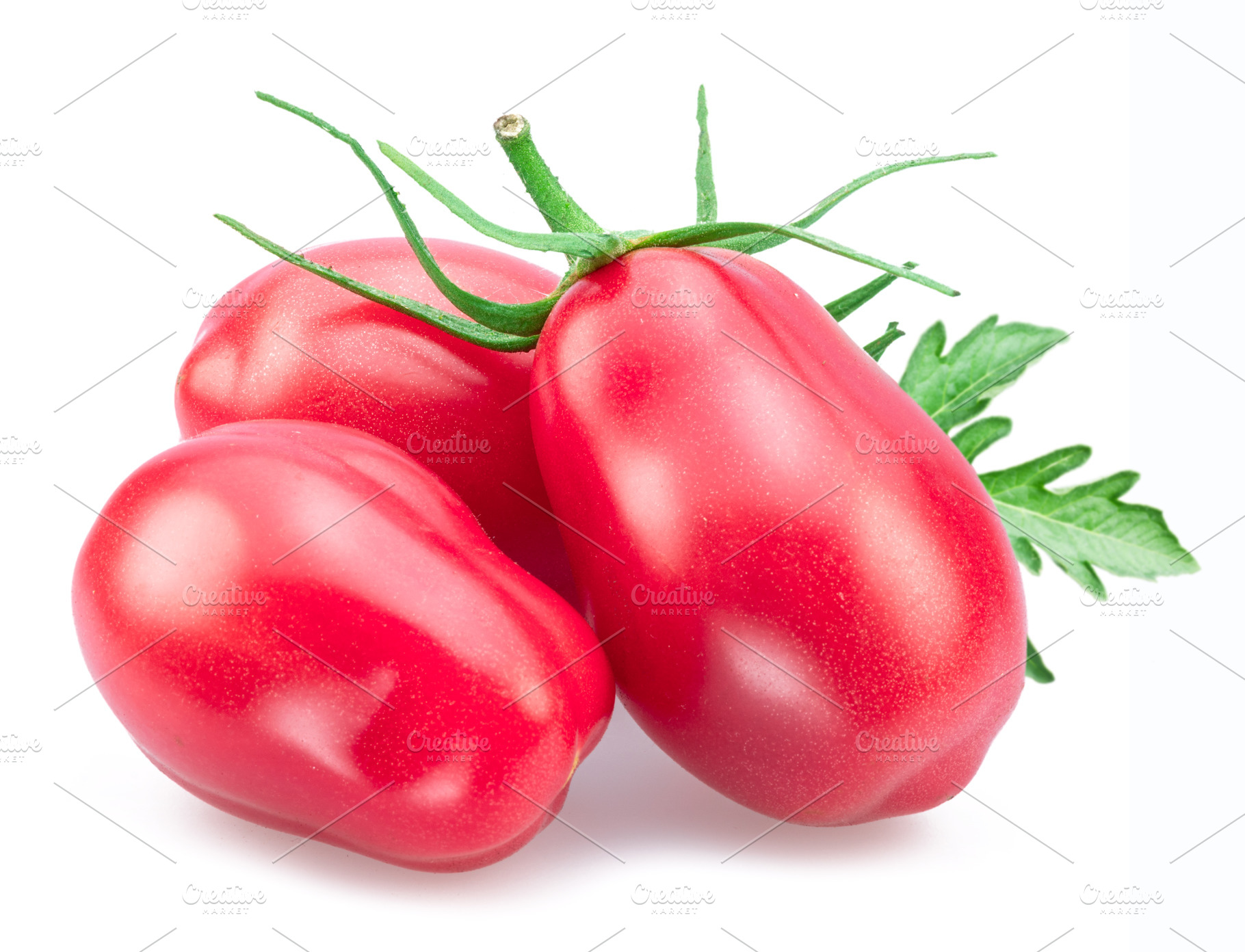 Three pink tomatoes (plums) with tomato leaves isolated on white, a Food & Drink Photo by Volff
