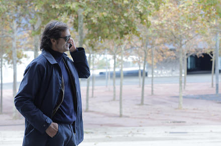 happy businessman walking outdoors with mobile phone., a Person Photo by 2Design
