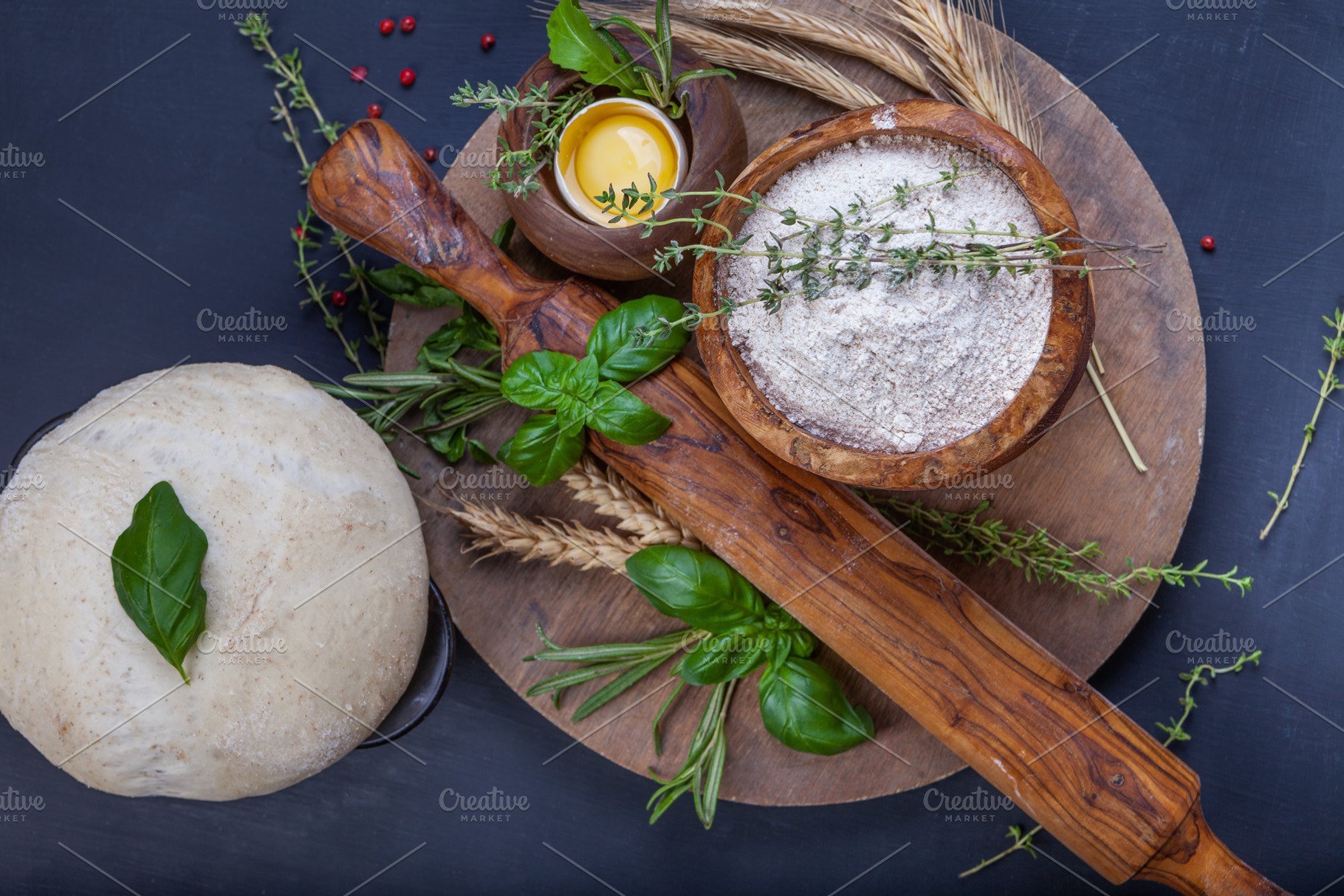 Pizza dough with egg, herbs and flour, a Food & Drink Photo by eleana