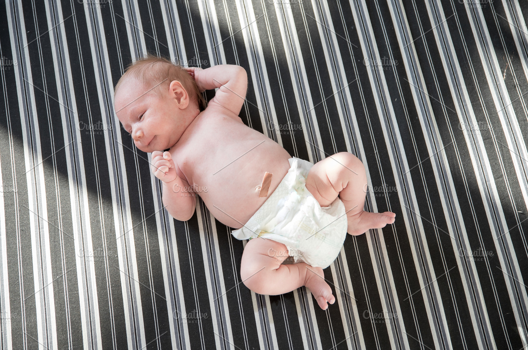 Cute newborn baby in a white diaper, a Person Photo by Barcelona_dreams