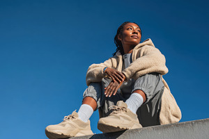 Woman sitting against blue sky, a Photo by Beautiful things