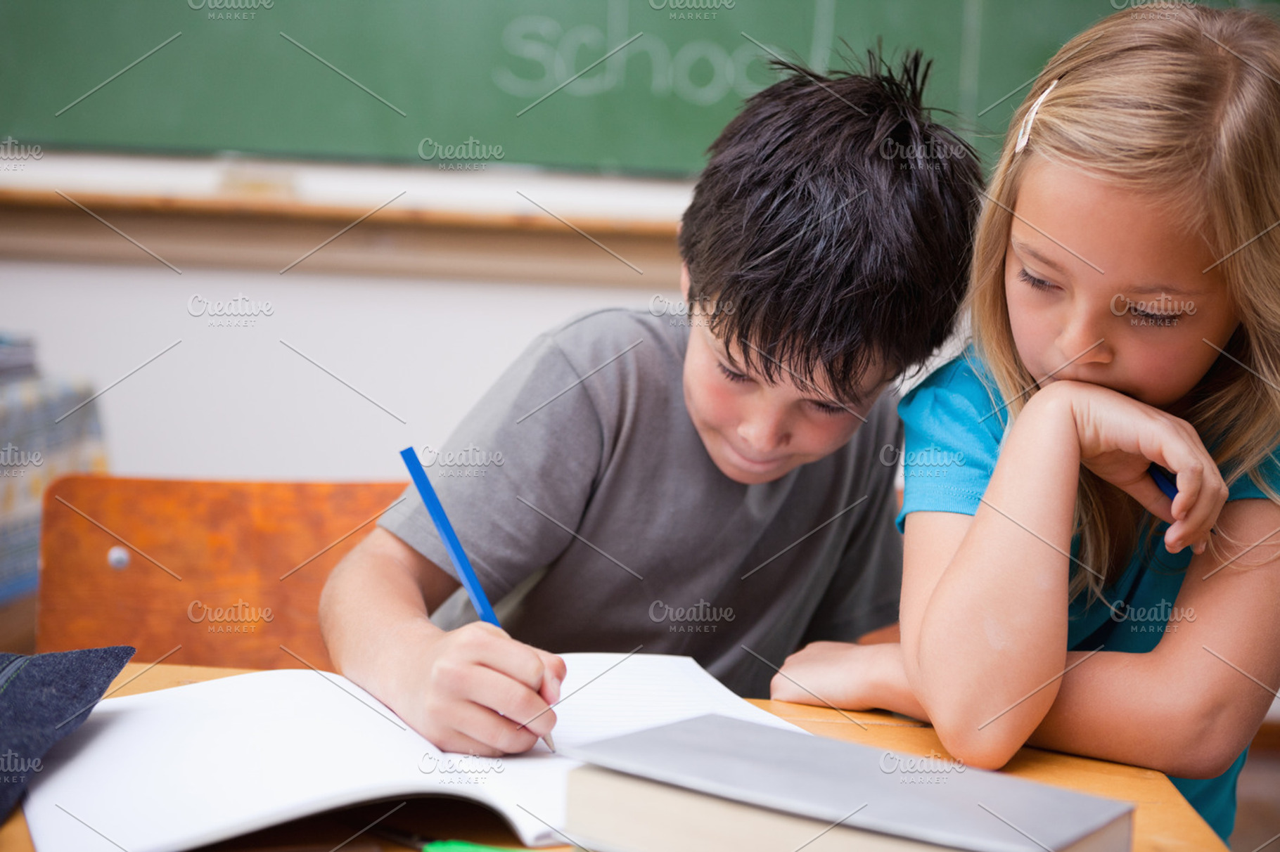 Serious pupils working together, a Photo by wavebreak