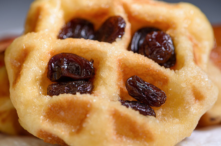Close up fresh waffles with above dried raisins