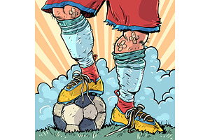 A soccer player's feet hold the ball