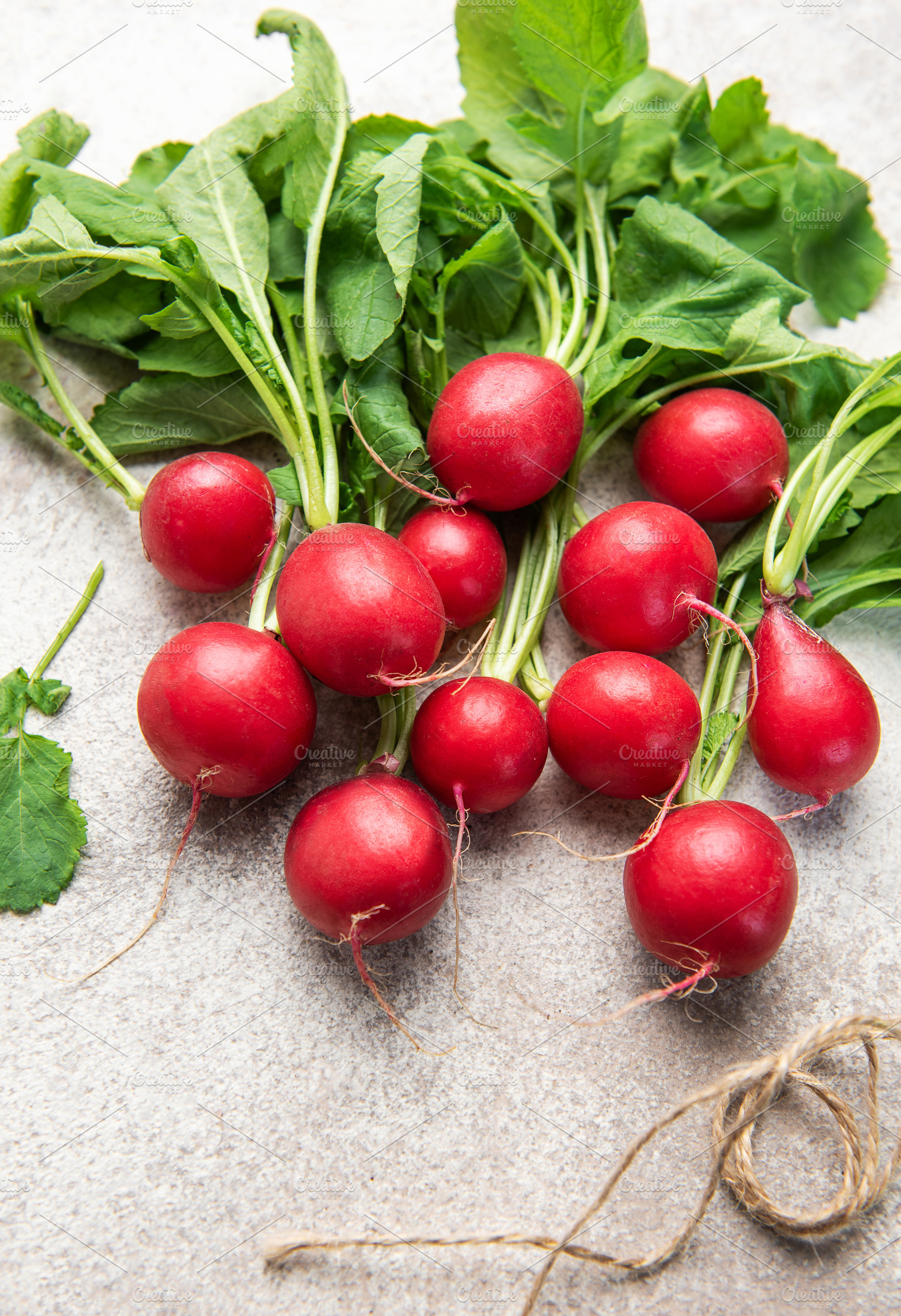 Fresh red radish with green leaves on kitchen counter, a Food & Drink Photo by Olena Rudo
