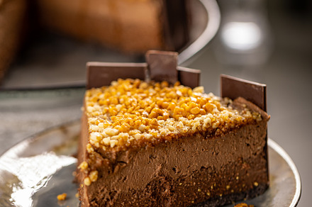 Close up of layered chocolate mousse cake, a Background Photo by Grafvision photography