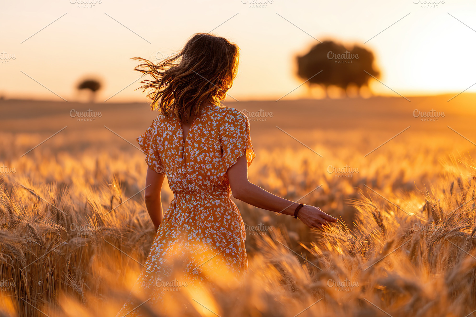 Woman in a yellow dress walks through a golden wheat field at sunset in summer, a Photo by AlyaAnd