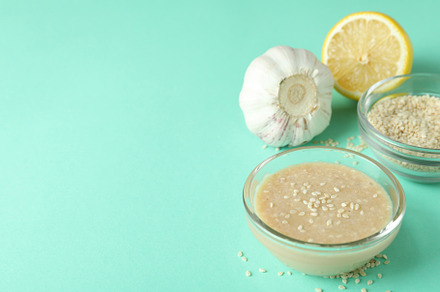 Concept of tasty food with tahini sauce on mint background, a Food & Drink Photo by AtlasStudio PRO