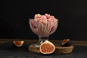 creamy sweet ice cream and sliced red fig fruits, a Photo by rsoollAI