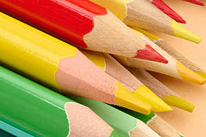 Multicolored wooden pencils stacked on a beige background, a School & Education Photo by ndanko