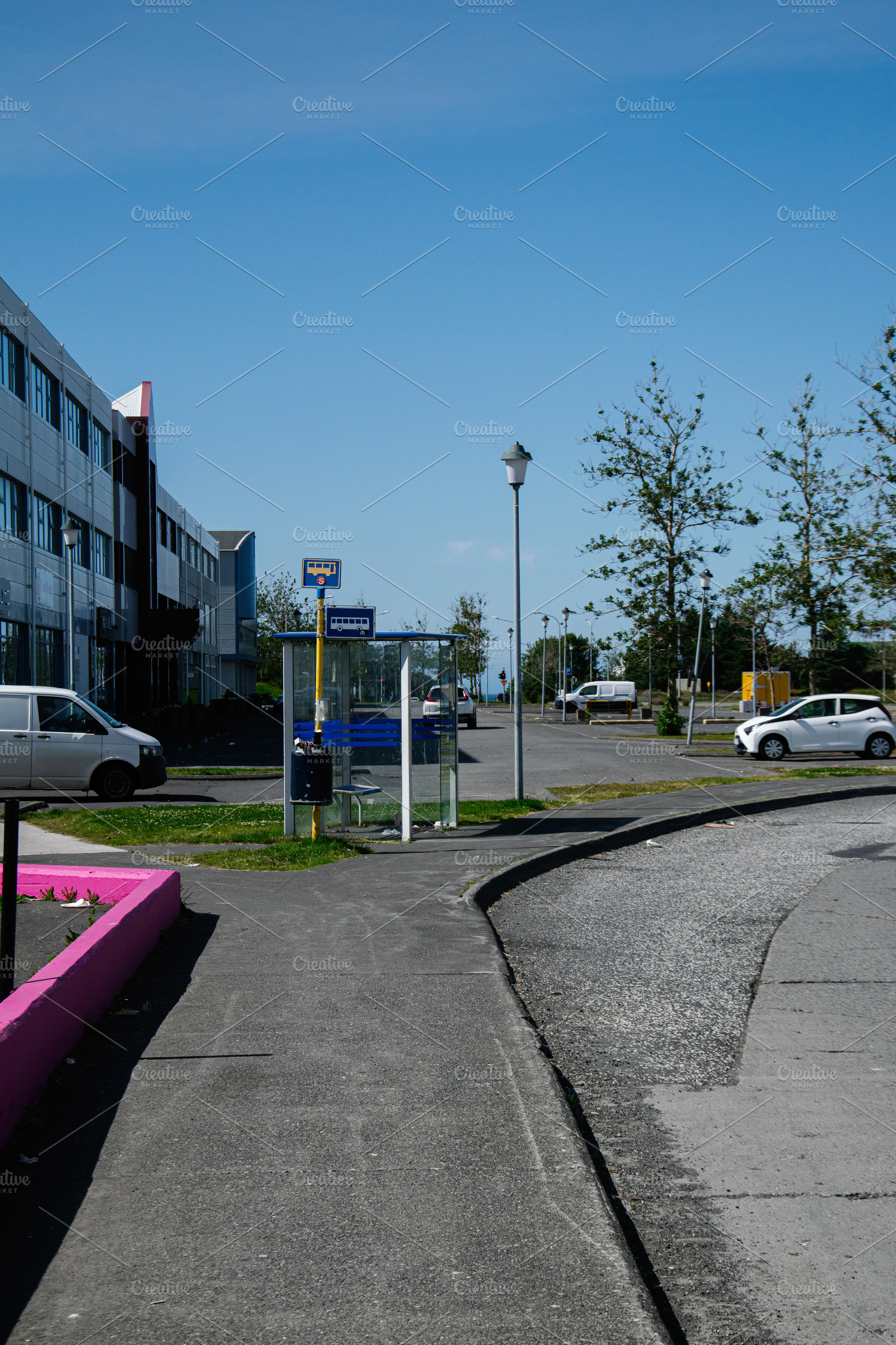 A bus stop in Akranes, Iceland with a clear sky and nearby park, a Photo by AS photostudio