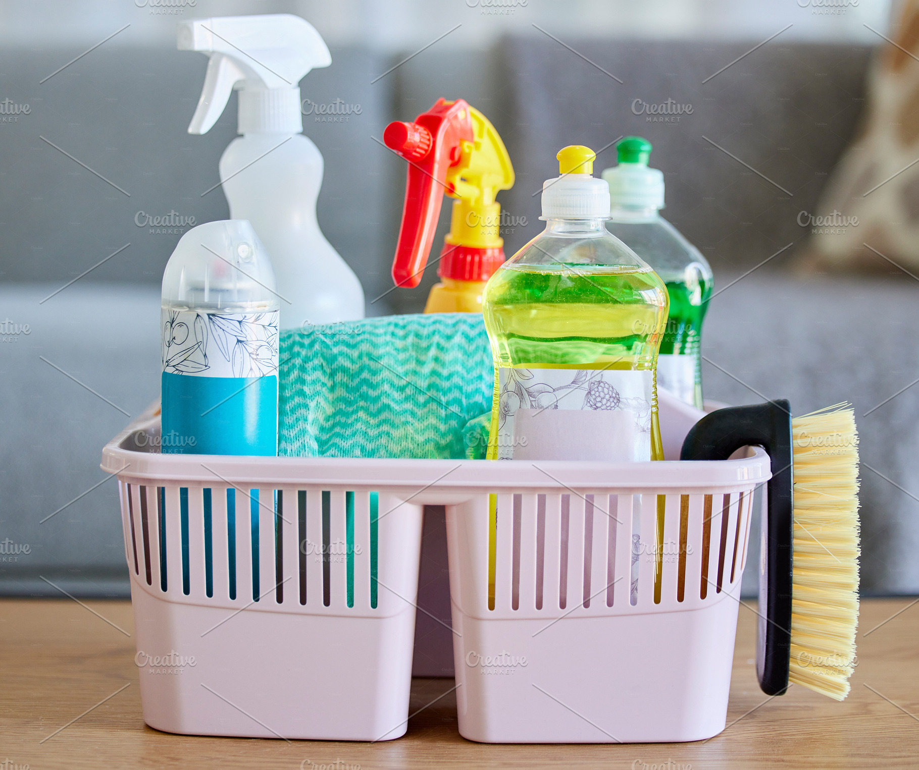 Cleaning supplies, brush and basket tools on table in home living room for hygiene. Cleaning products, spring cleaning and equipment for creating germ free living space, sanitizing or washing., a Photo by Peopleimages.com