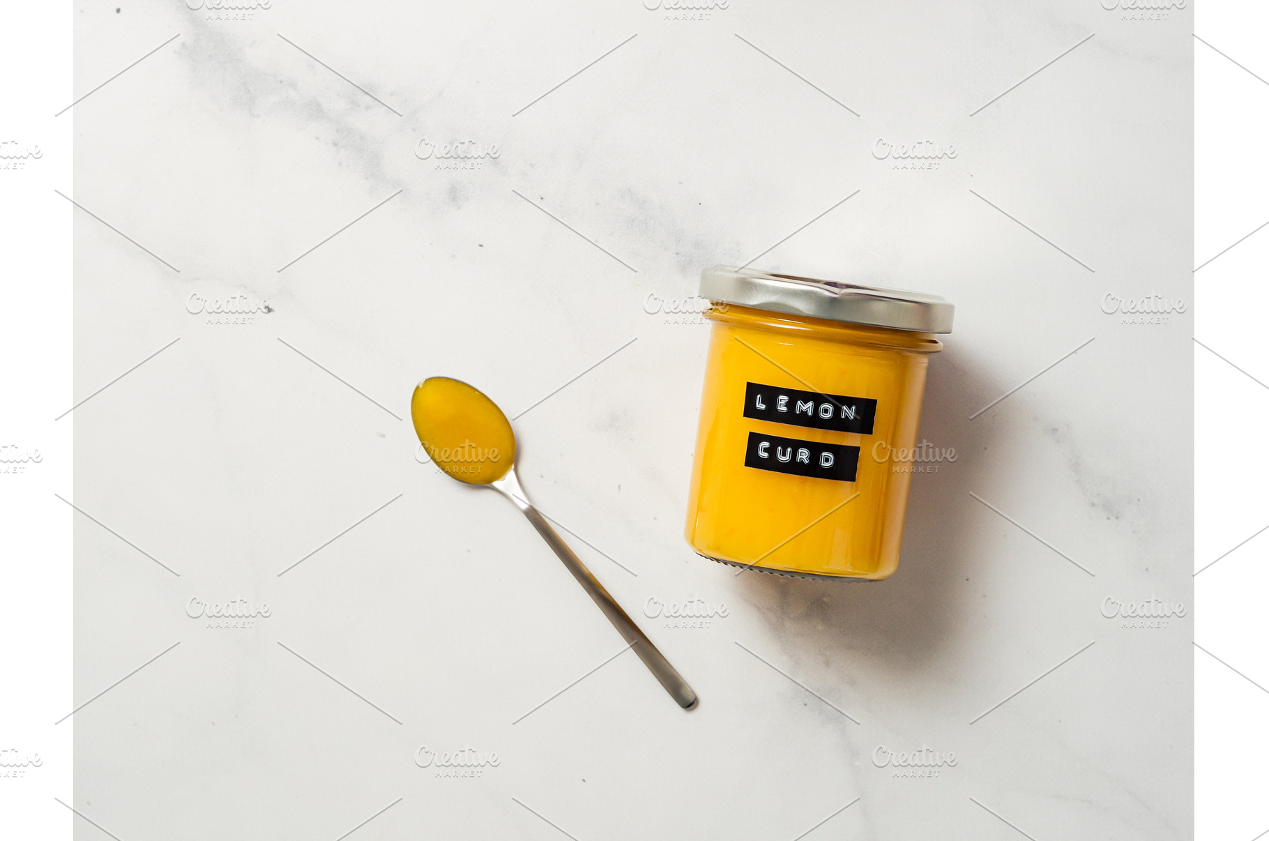 Homemade lemon curd in jar, top view, a Food & Drink Photo by Fascinadora