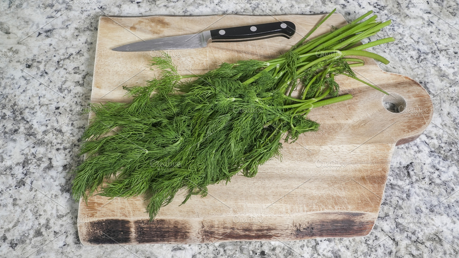 Fresh dill sprigs on wood cutting bo, a Food & Drink Photo by 1miromiro