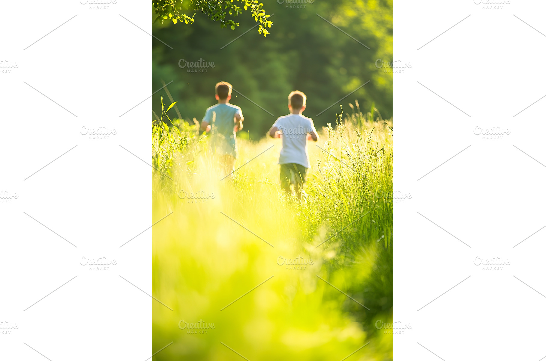 Two boys running through sunlit, a Person Photo by Lermont51