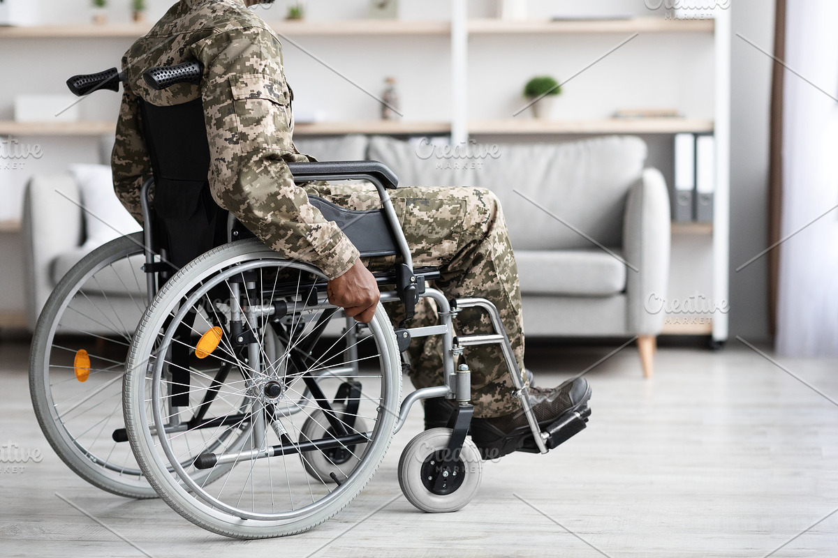 Cropped of black veteran in wheelchair rolling by home, a Photo by Prostock-Studio (Photo 1 of 3)