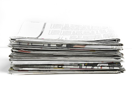 Newspapers folded and stacked featuring advertise, advertisement, and