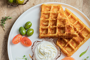 Crunchy waffle fries with sour cream dip served in a basket, a Food & Drink Photo by Budarinphoto