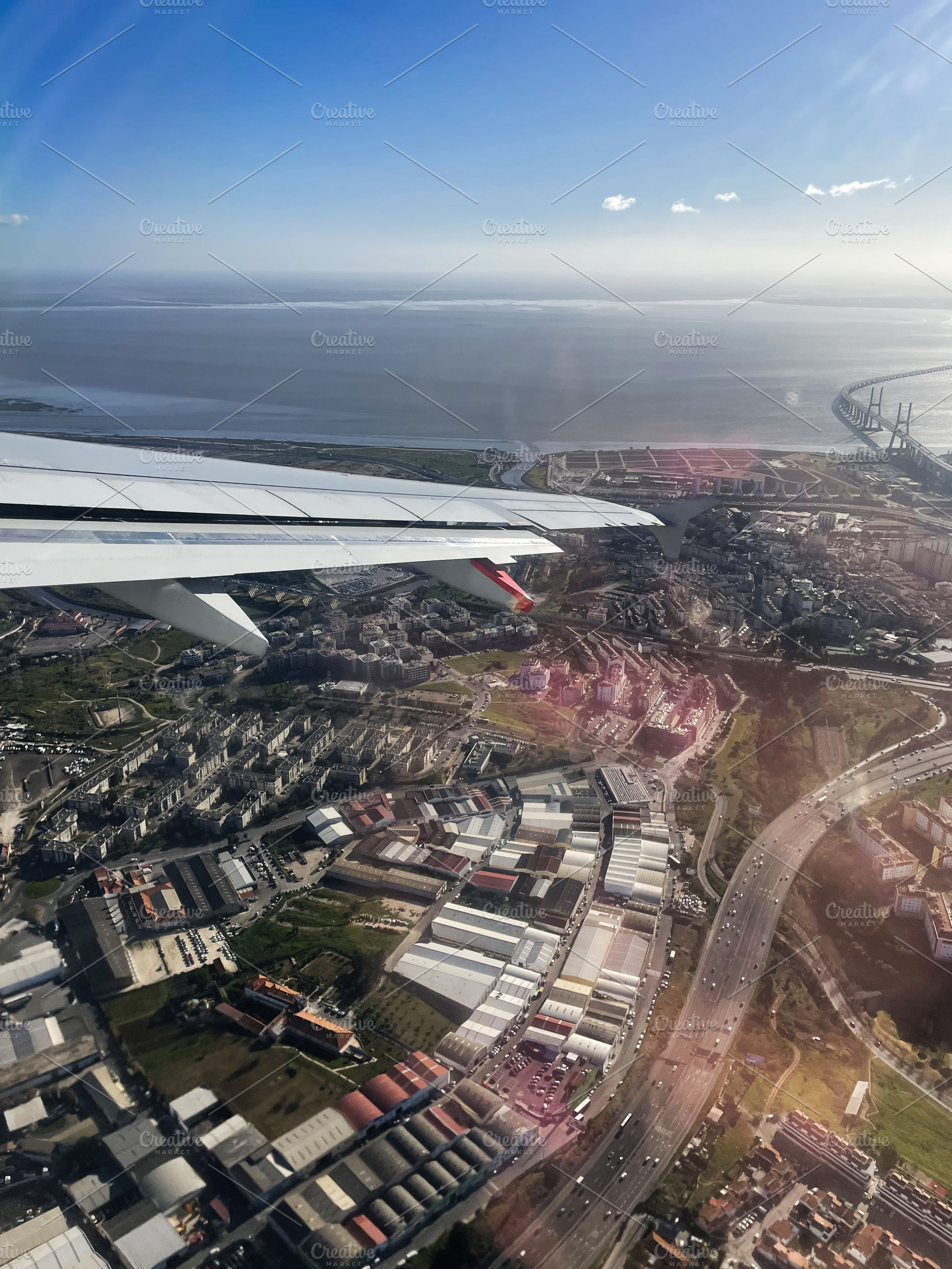 Aerial view of Lisbon coast with Vasco da Gama bridge and cityscape visible, a Photo by AS photostudio