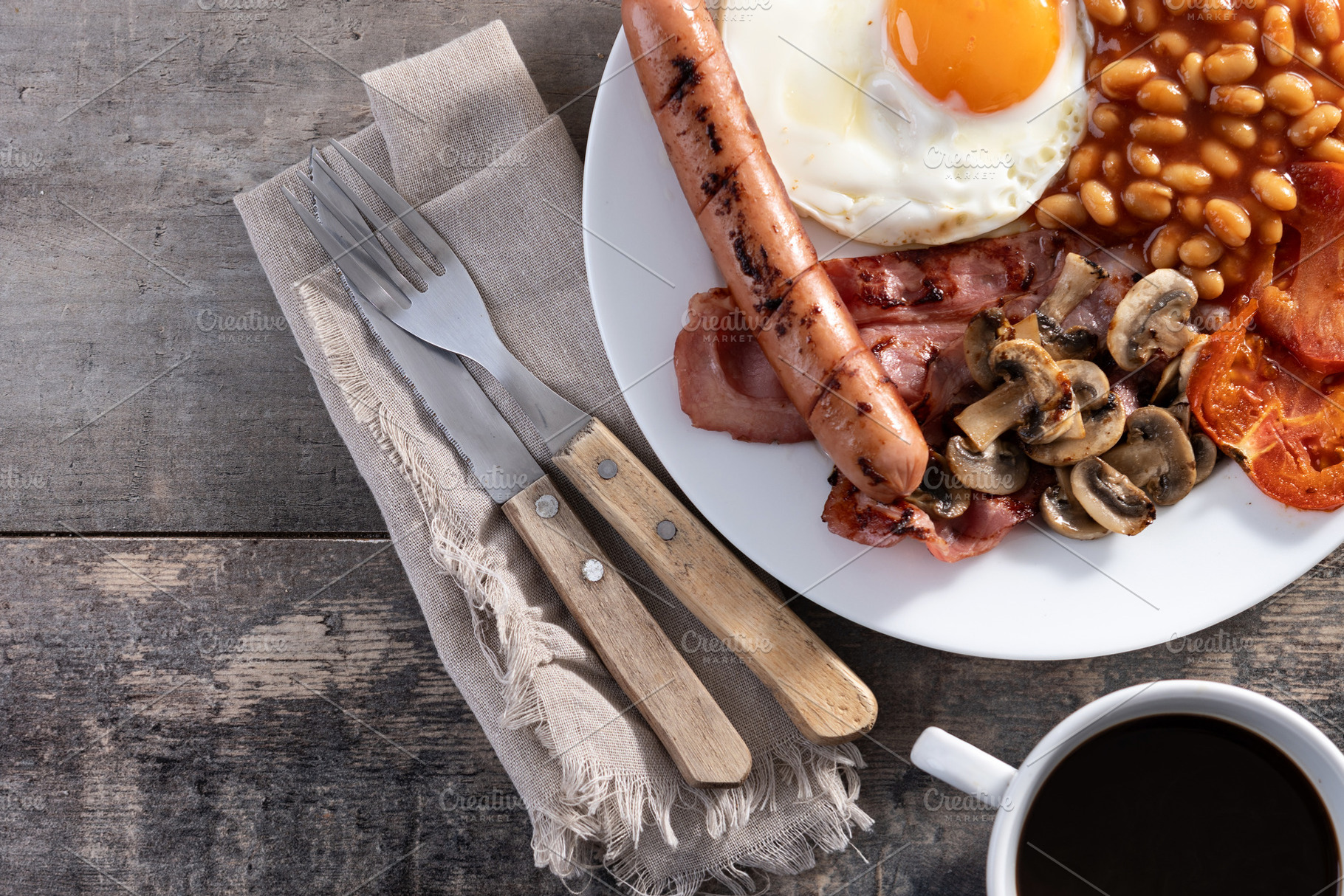 Full English breakfast with fried egg, bacon, sausages and beans, a Food & Drink Photo by etorres69