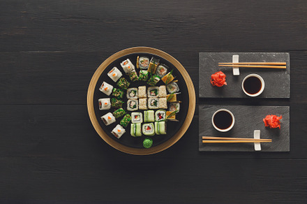 Set of sushi maki and rolls on black featuring asian, assortment, and, a Food & Drink Photo by Prostock-Studio