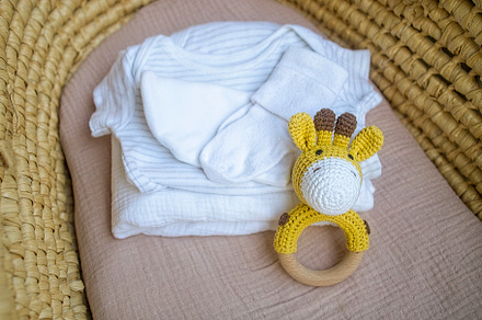 basket there are things for the baby and wooden and knitted toys