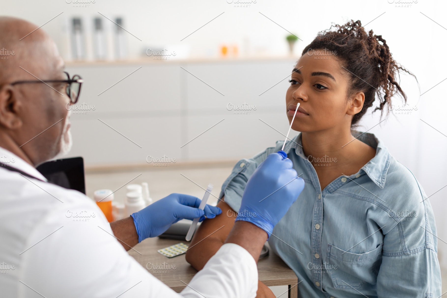 Doctor taking PCR test sample from potentially infected black woman, a Photo by Prostock-Studio