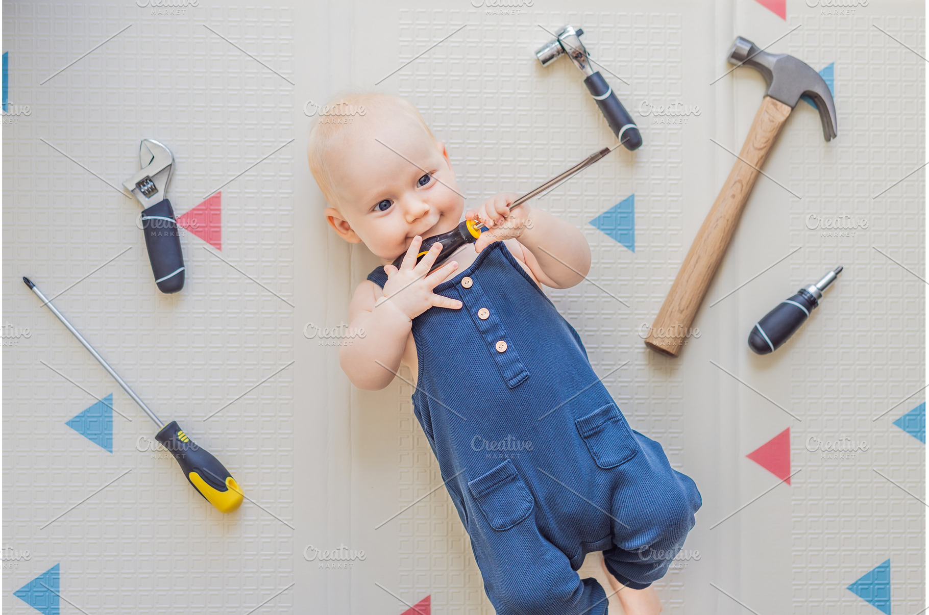 Adorable baby in a mechanic costume, an Industrial Photo by Elizaveta Galitskaya