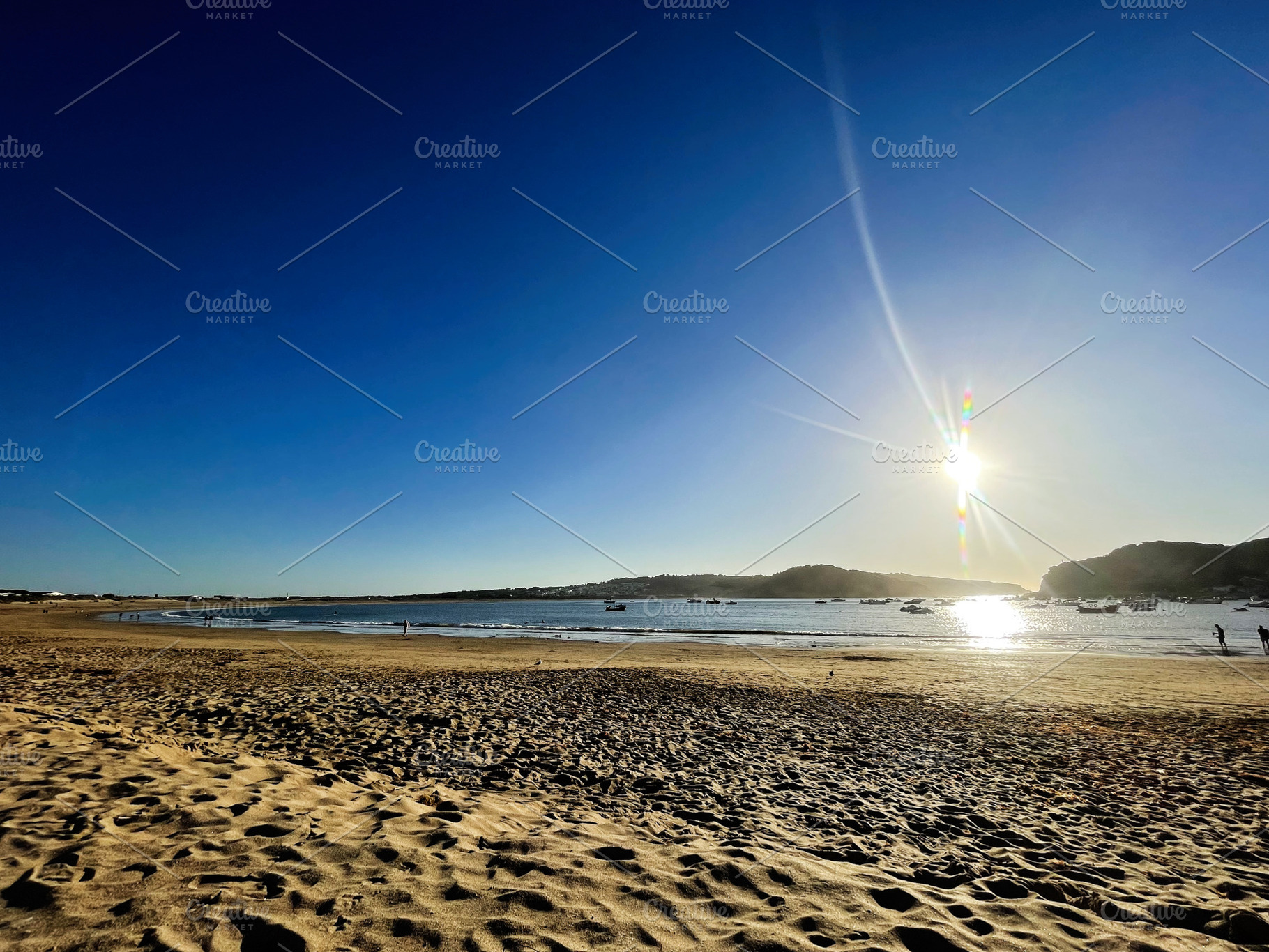 Golden beach at sunset in Cascais ,Portugal during a serene evening, a Photo by AS photostudio