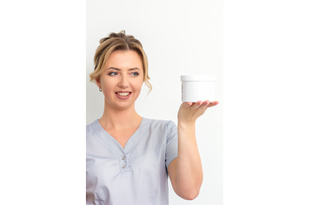 Beautician holding a jar of wax for, a Beauty & Fashion Photo by okskukuruza
