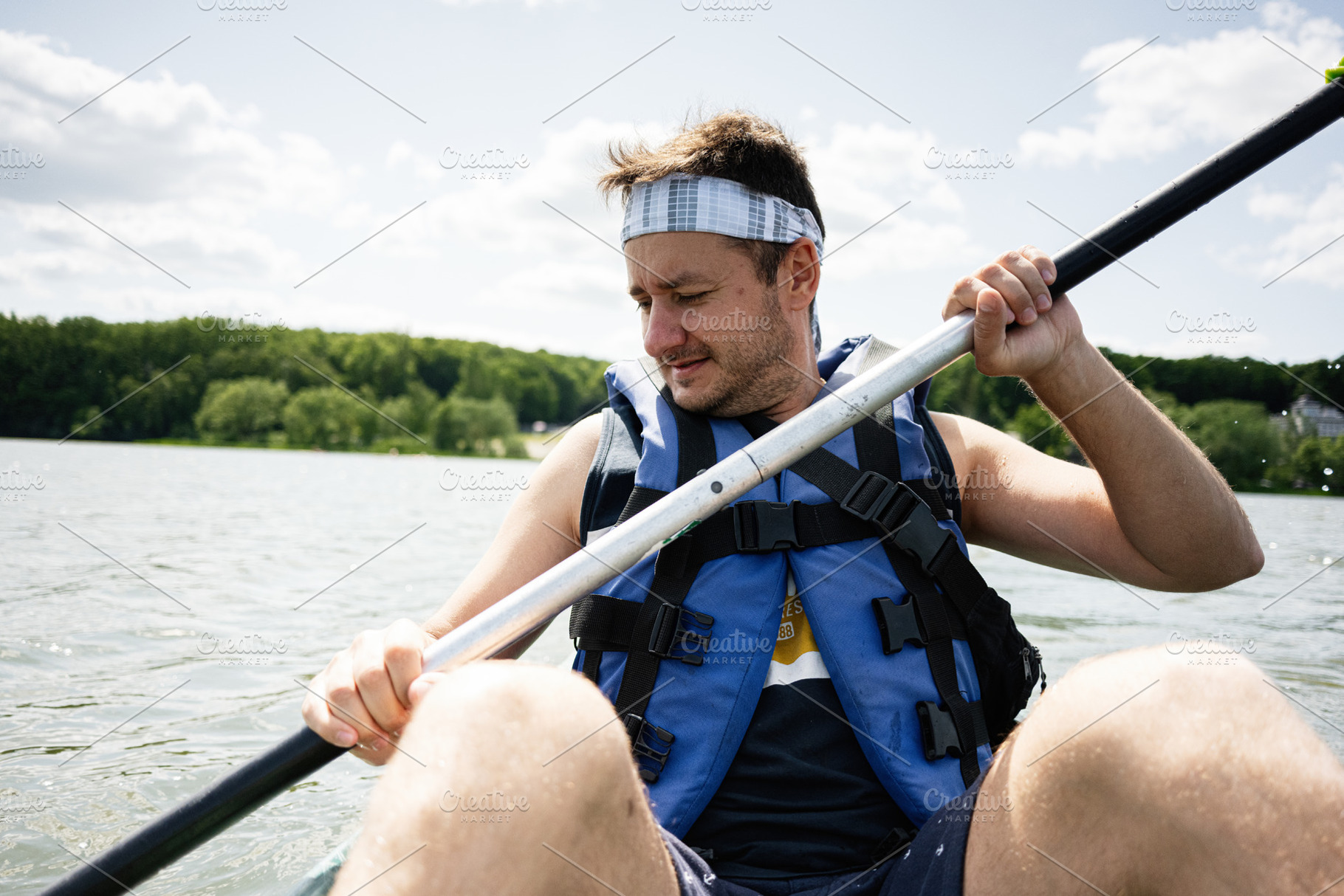 Man paddling on a serene lake with greenery in the background, a Photo by AS photostudio