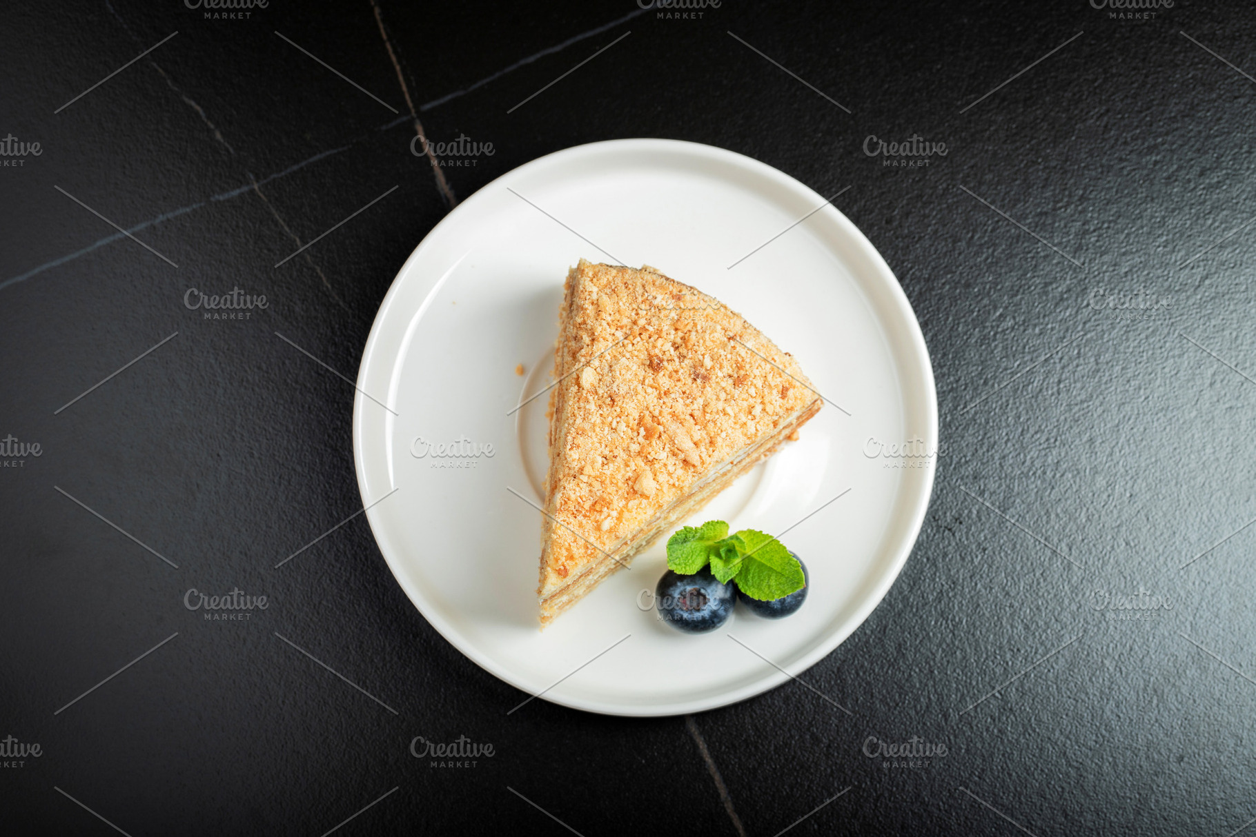 Medovik. Honey cake made from honey cakes with whipped sour cream, decorated wi, a Food & Drink Photo by Budarinphoto