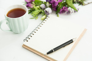 Desk with tea notebook and flowers stock photo containing notebook and tea
