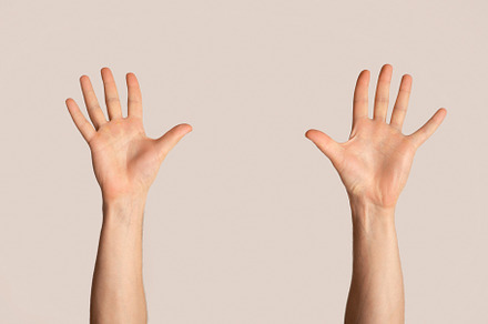 Millennial man raising both hands up, a Background Photo by Prostock-Studio