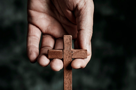 man with a wooden cross in his hand, a Photo by Nito