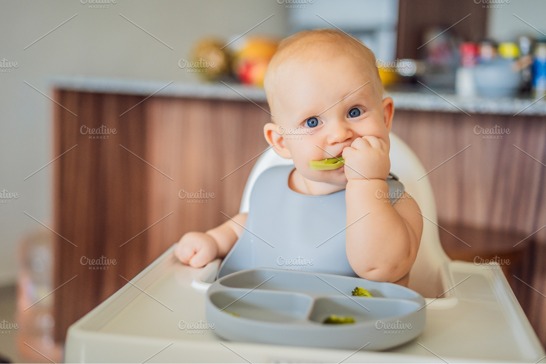 Baby enjoying green vegetables, a Person Photo by Elizaveta Galitskaya